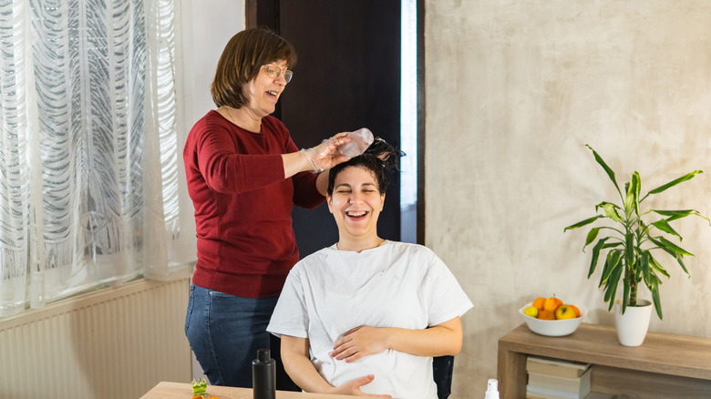 Pregnant woman getting hair dyed