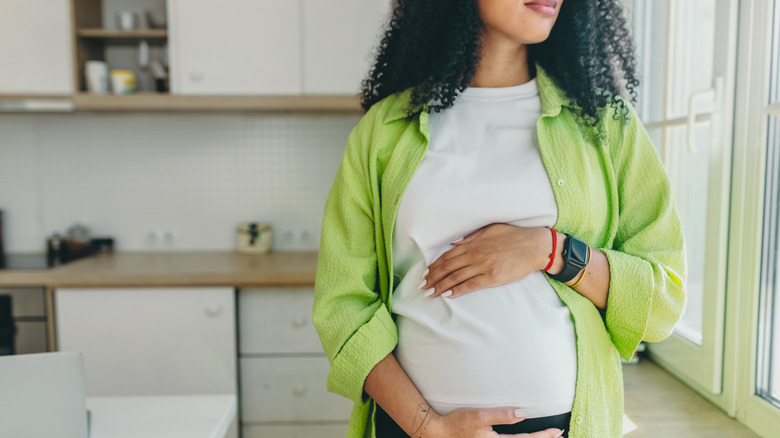 Pregnant woman holding stomach