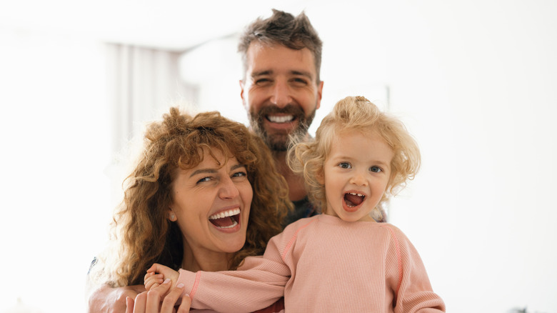 Happy parents with toddler girl