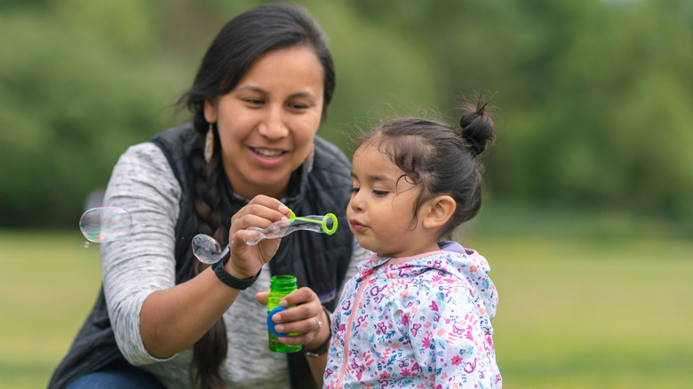 Mom and daughter blowing bubbles