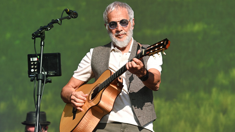 Cat Stevens playing guitar outdoors