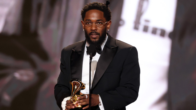 Kendrick Lamar holding Grammy Award
