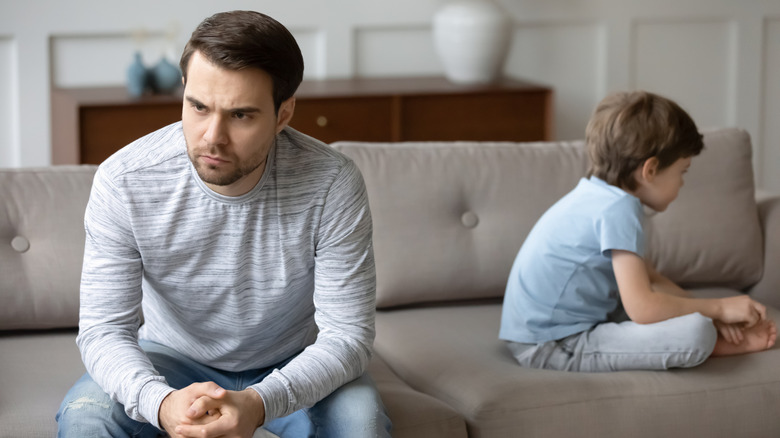 Father and boy looking in opposite directions