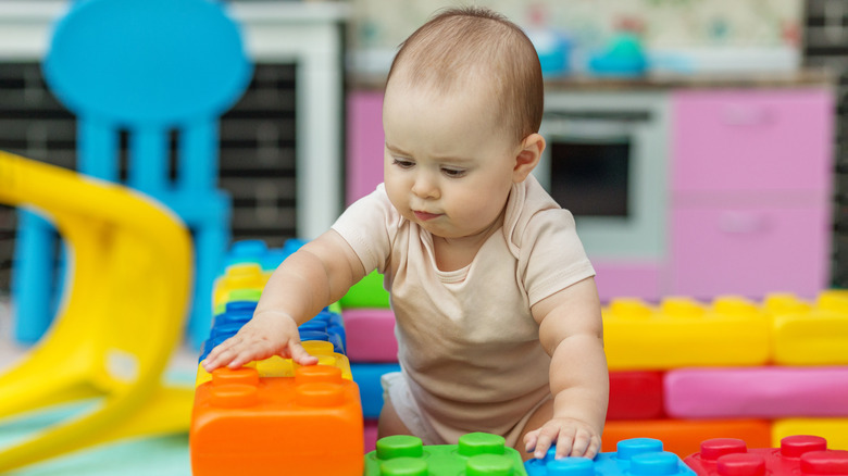 Baby playing with rainbow blocks