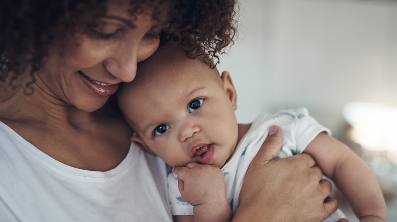 Mom holding a baby close
