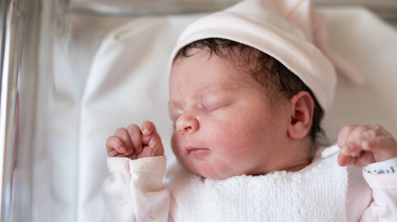 Baby sleeping in hospital bed