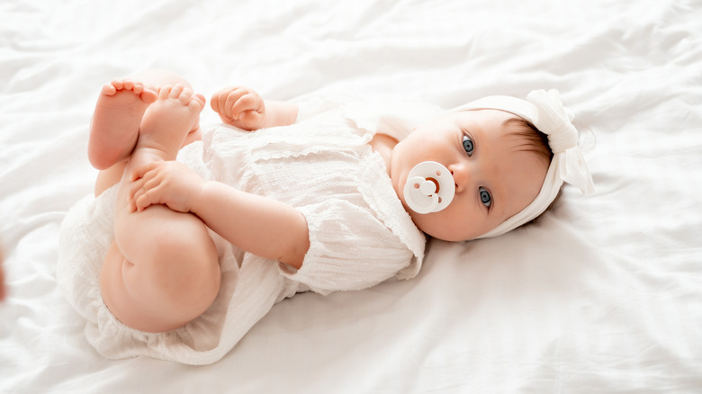 Baby holding her feet