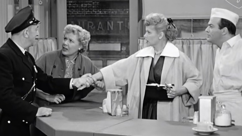 A police officer, Ethel, Lucy, and an ice cream shop in an episode of "I Love Lucy"