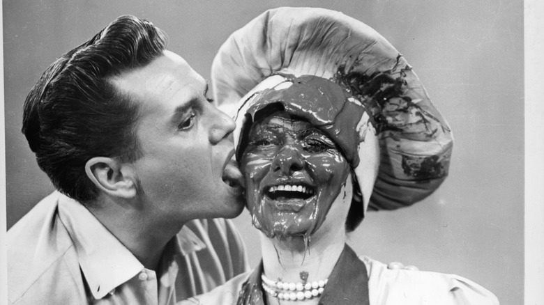 Ricky (Desi Arnaz) licks wife Lucy (Lucille Ball) on the face in "I Love Lucy"