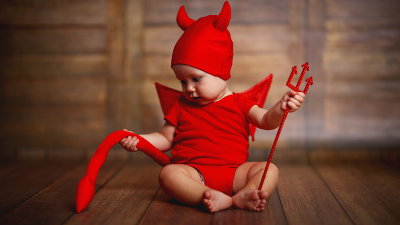 Baby dressed in devil costume