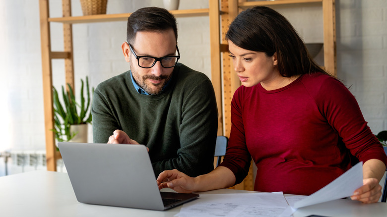 Husband and wife research baby name documentation rules together