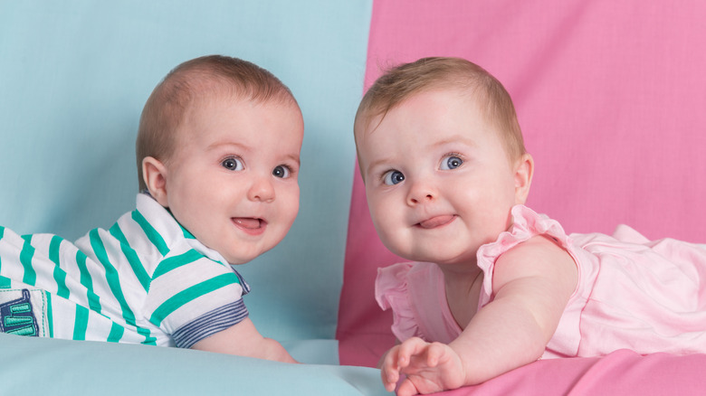 Boy and girl babies looking up