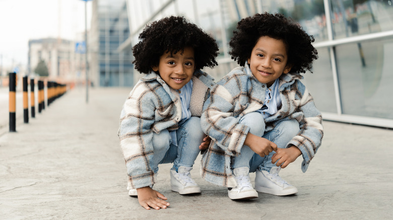 Black twin boys in plaid coats