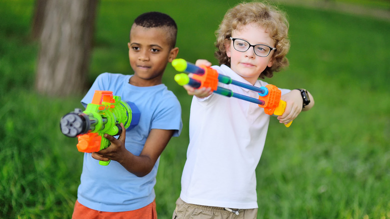 Two young boys playing with toy guns