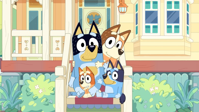 Bandit, Chilli, Bluey, and Bingo sit in front of their house in "Bluey"