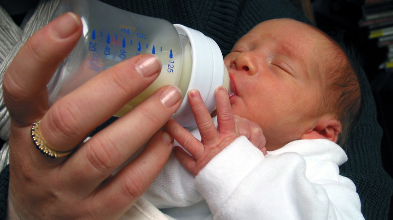 newborn baby drinking from a bottle
