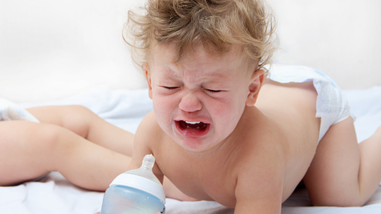 Crying baby with bottle