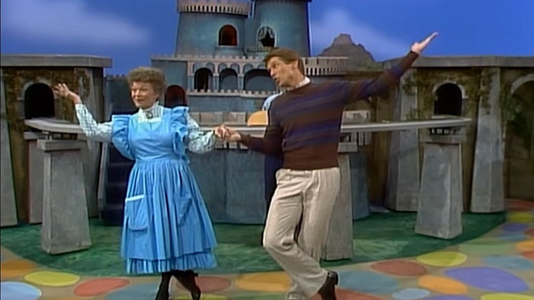 Neighbor Aber dances with Miss Audrey Paulificate in front of the Make-Believe castle