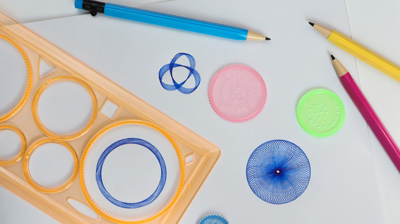 spirograph toys and pencils on a table