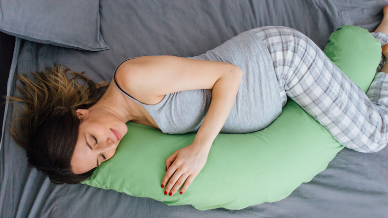 Pregnant woman sleeping on pillow