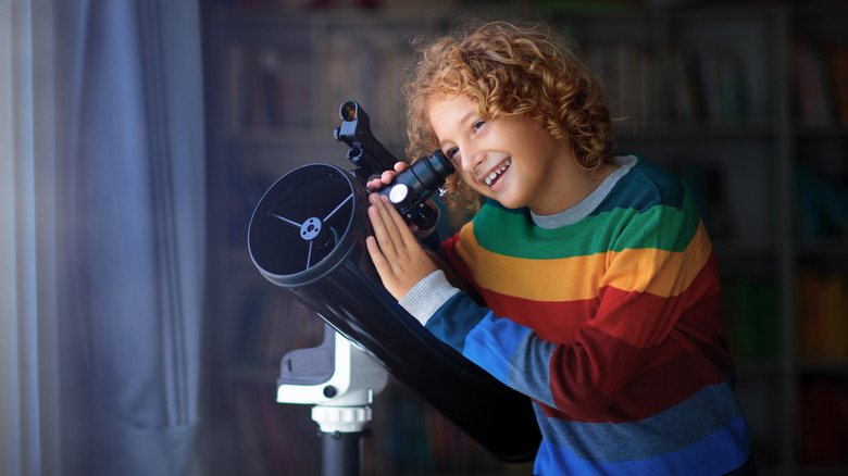 Children in room with telescope