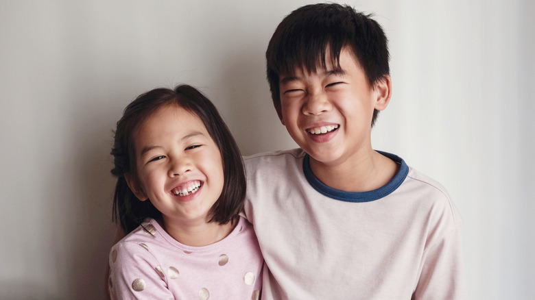 Asian brother and sister laughing