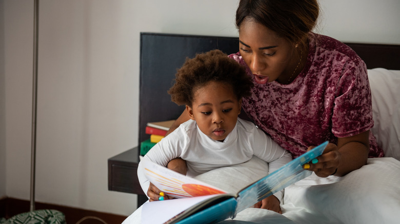 woman reading to child in bed