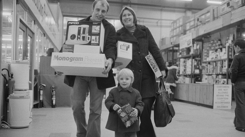 1970s parents and kid shopping holding boxes