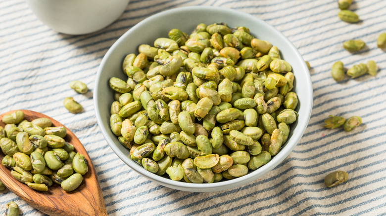 Woman eating edamame as a snack