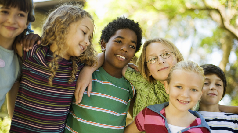 group of smiling girls and boys