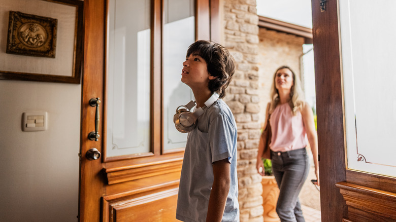 Mother dropping her son at a house