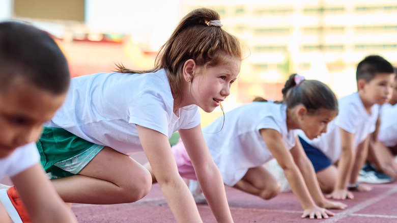 children preparing to run a track race