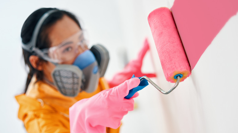 woman painting in protective gear