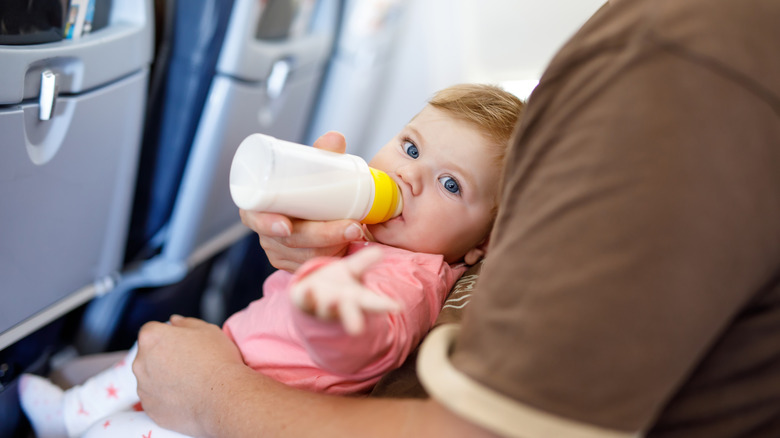 Baby having a bottle on plane
