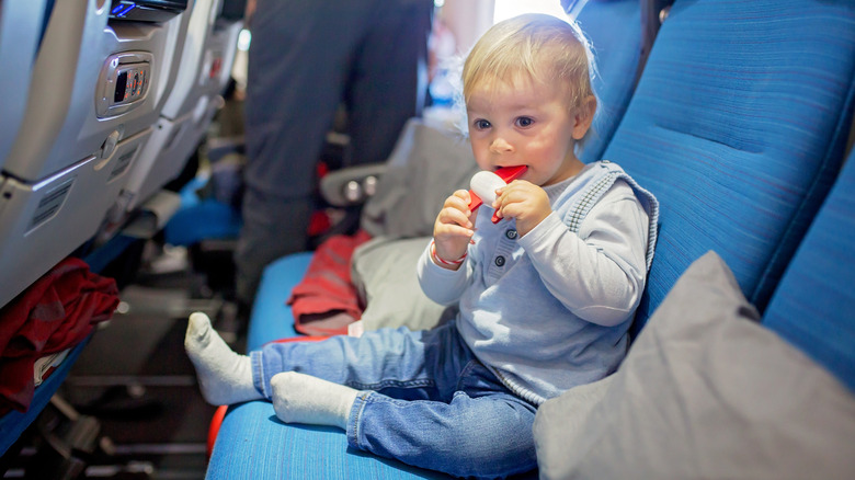 Child playing with a toy on airplane