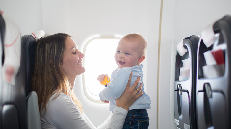 Mom holding smiling baby