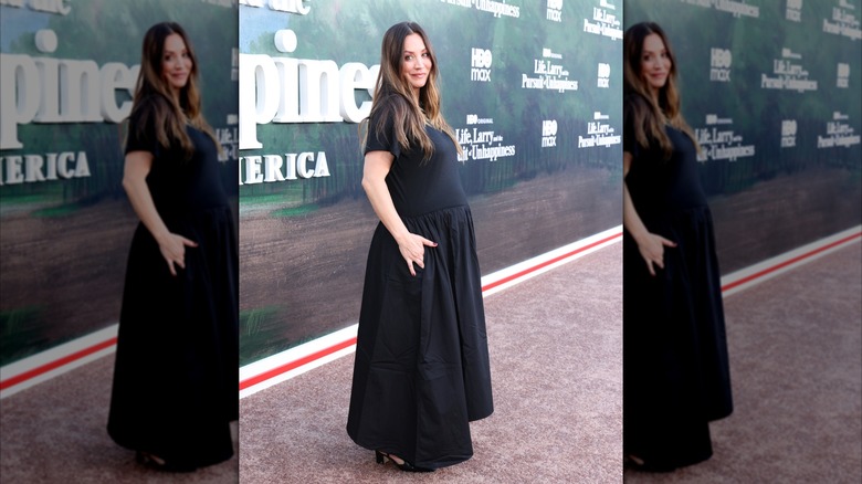 Kaley Cuoco poses in a black dress