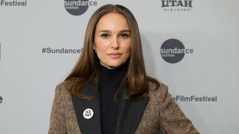 Natalie Portman in a black shirt and brown blazer