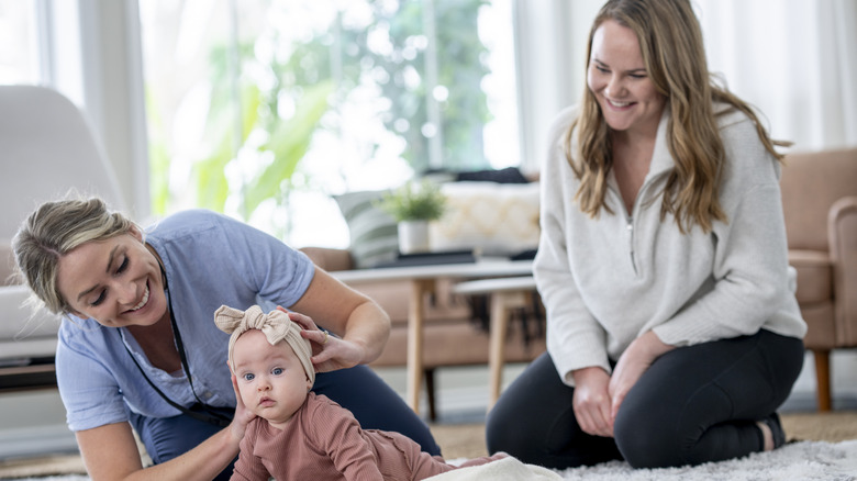 Mom, nanny, and baby together