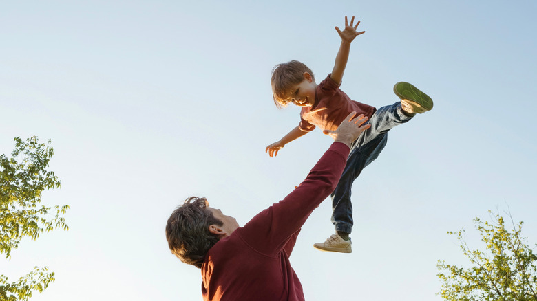 dad playing with toddler outside