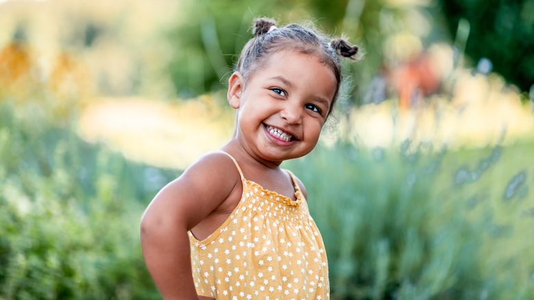 smiling little girl playing outside