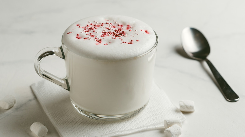 Mug of steamed milk with sprinkles