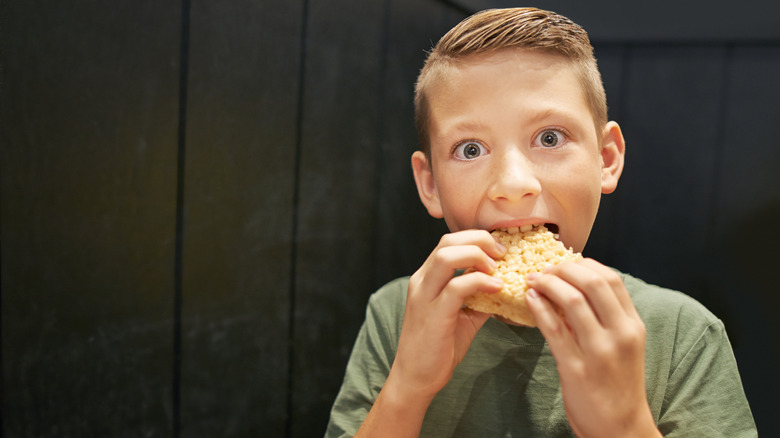 Boy eating a rice krispie treat