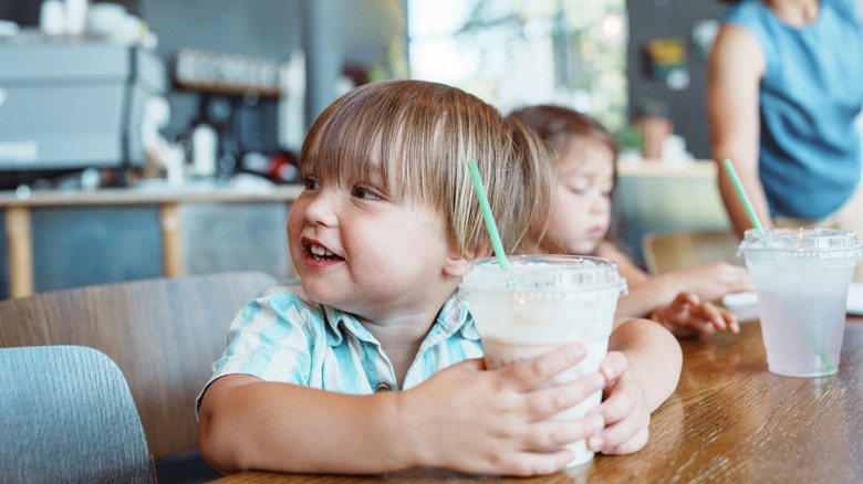 Child enjoying a frappucino drink at Starbucks