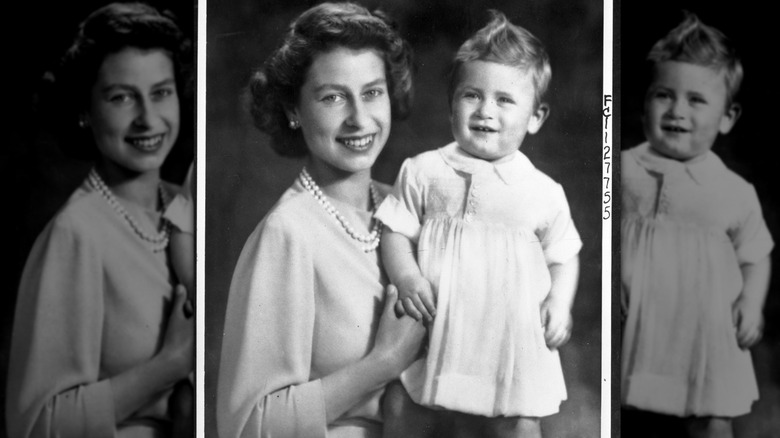Queen Elizabeth smiling while holding a standing King Charles