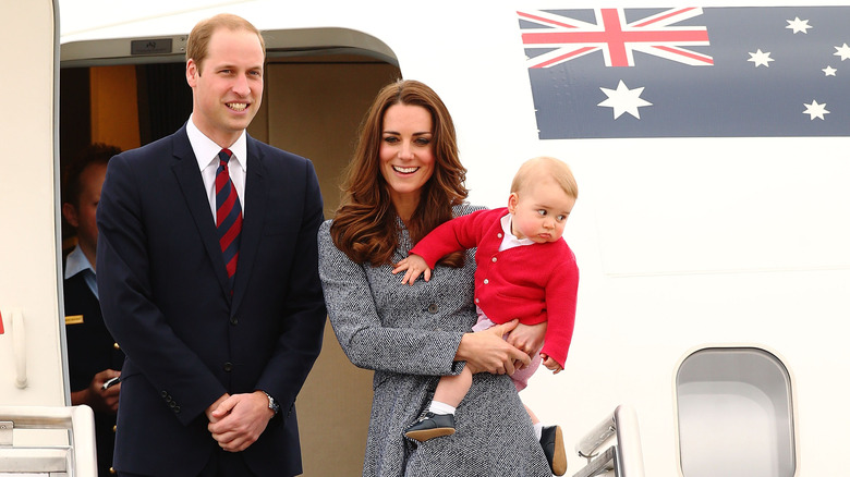 William, Prince of Wales smiling and Catherine, Princess of Wales smiling and holding baby Prince George