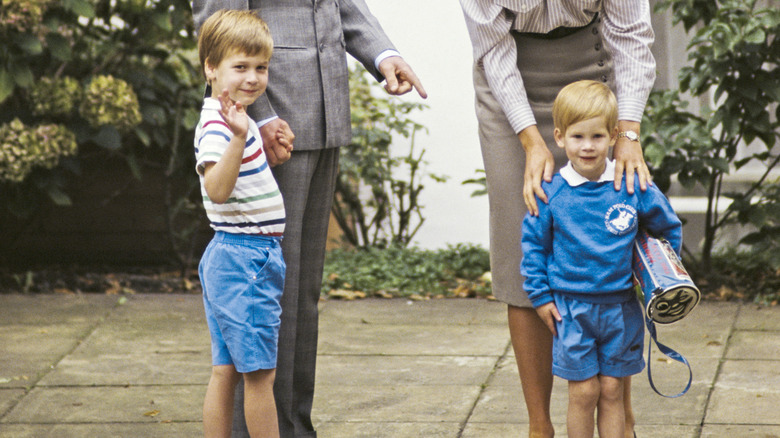 Prince William and Prince Harry smile in a photo as children