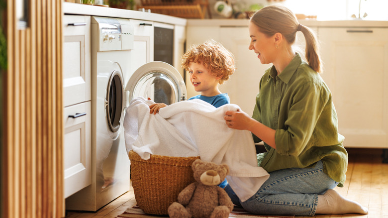 women and child doing laundry together