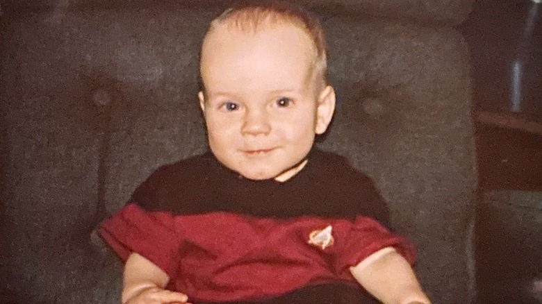 Baby boy wearing red "Star Trek" onesie