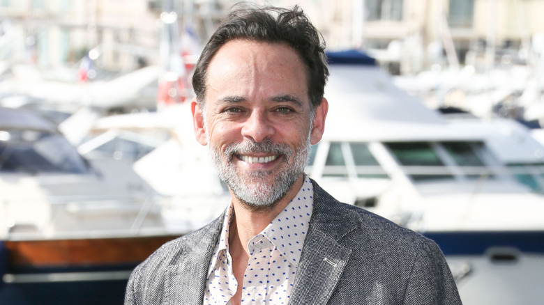 Alexander Siddig near boats in tweed jacket
